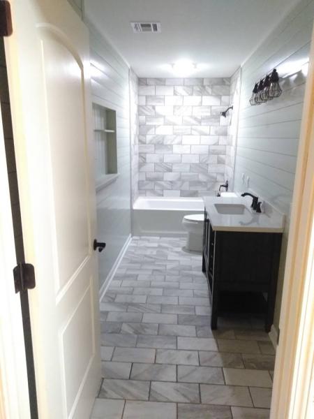 Nothing transforms a bathroom quite like the installation of new tiling! This multi-colored subway tile adds sleekness to this bathroom renovation. 
